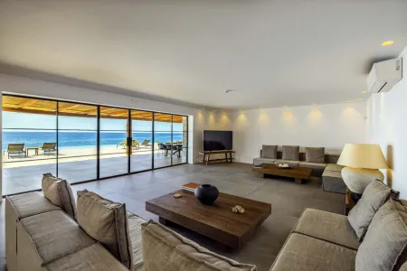  Bright living room with large windows facing the sea