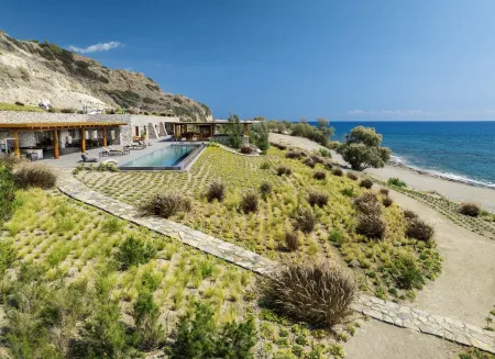  Outdoor terrace with pool, landscaped garden, and beach