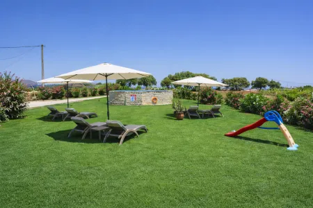 Pool area with sunbeds and slide