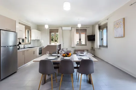 Kitchen area with a living room and dining table